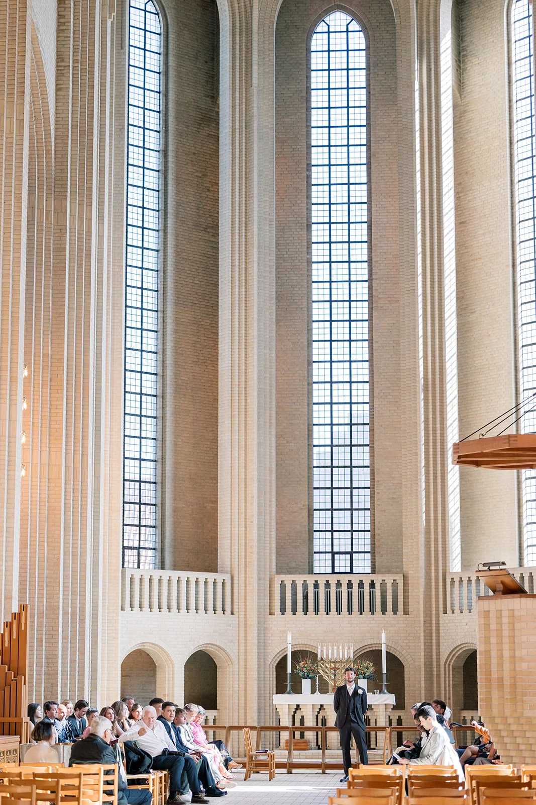 Tall sunlit windows inside a wedding ceremony venue