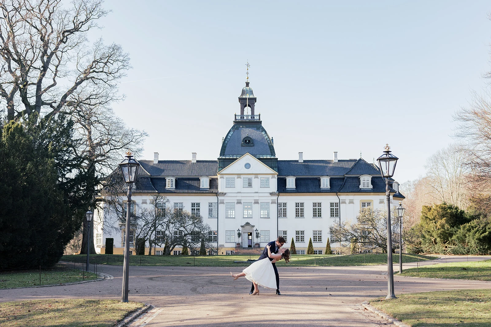 A couple dancing outside a pale stone country house