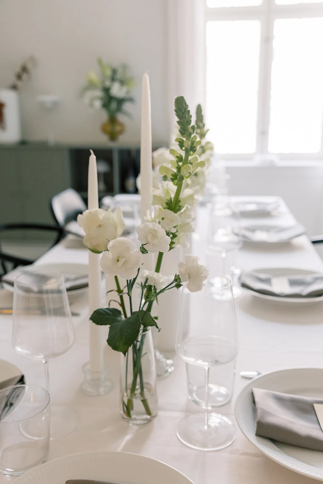 A wedding table set with white flowers and candles