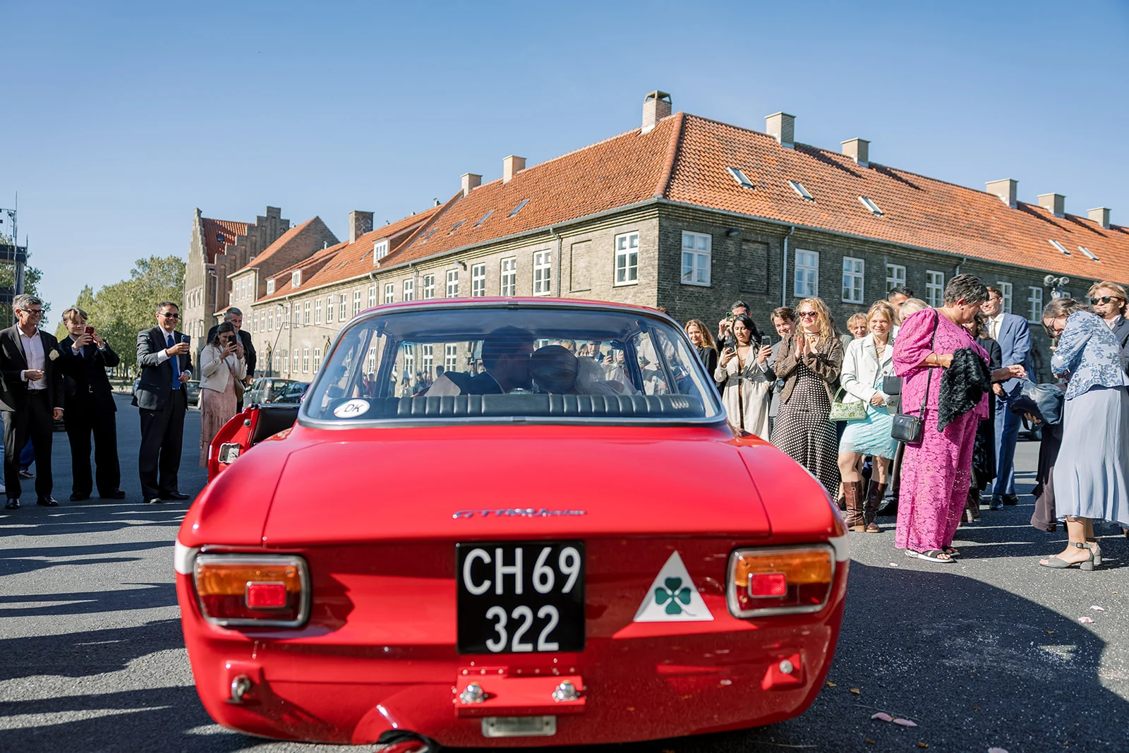 A red vintage car decorated for a wedding